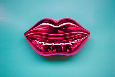 High angle view of heart shape on table against blue background