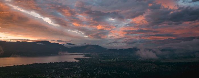 Scenic view of dramatic sky over lake during sunset