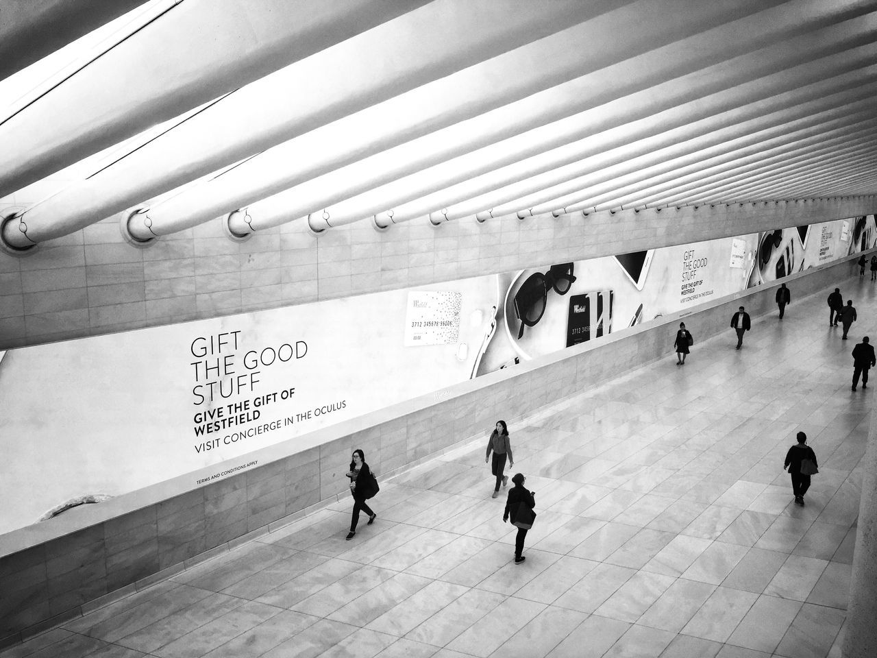 group of people, real people, architecture, large group of people, men, built structure, crowd, women, lifestyles, walking, adult, transportation, high angle view, indoors, travel, day, leisure activity, public transportation, city, flooring, tiled floor, ceiling, architectural column