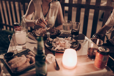 Midsection of woman having food at restaurant