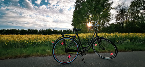 Bicycles on field against sky