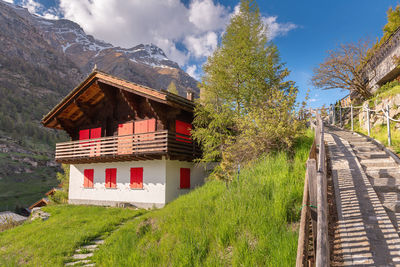 House on mountain against sky