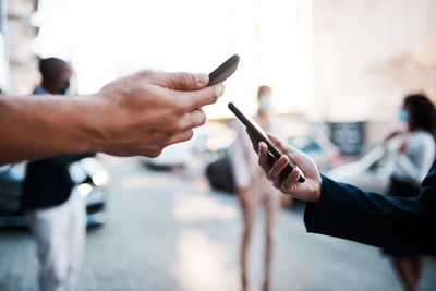 Cropped hand of man using mobile phone