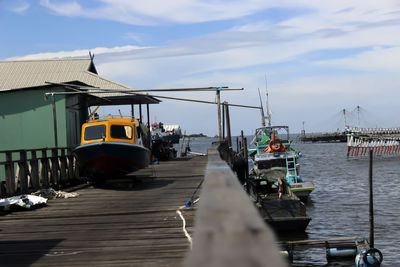 Boats moored at harbor