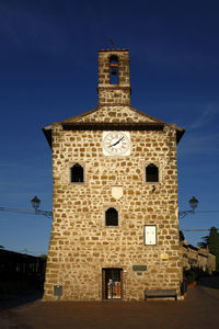 Low angle view of historic building against blue sky