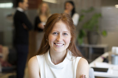 Portrait of smiling female entrepreneur in office