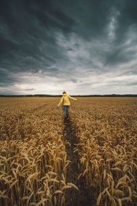 Man standing on field against sky