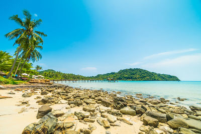 Scenic view of sea against blue sky during sunny day