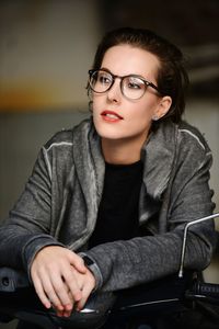 Young woman looking away while sitting on motor scooter