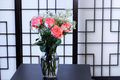 Close-up of roses in vase on table