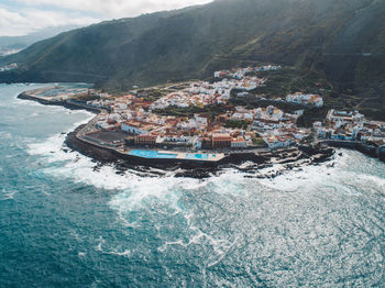 Aerial view of sea and buildings in city