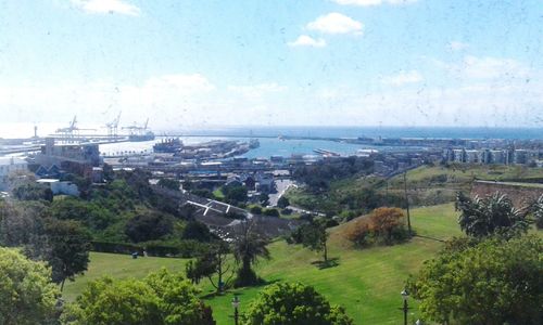 Scenic view of sea and city against sky