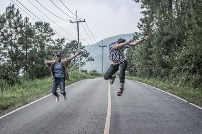 Full length of man jumping on road