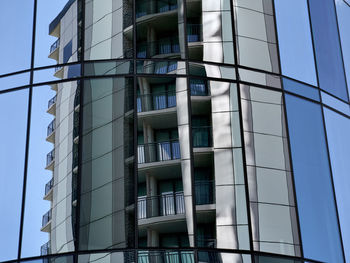 Low angle view of modern building against clear blue sky