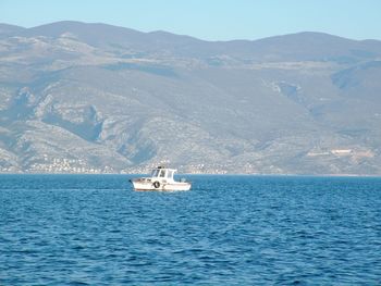 Sailboat sailing on sea against sky