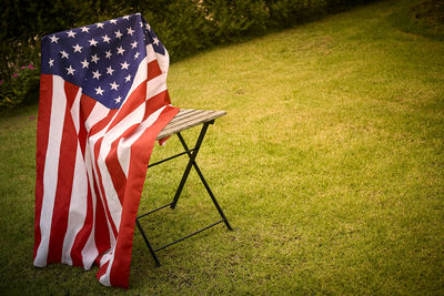 High angle view of american flag on chair at yard