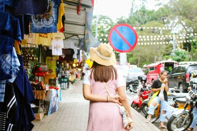 Woman standing on street in city