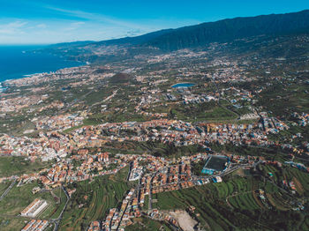 High angle view of townscape by sea against sky