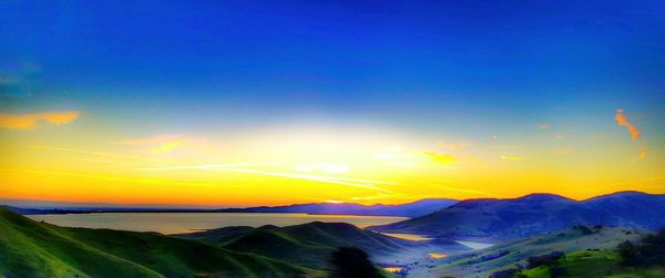 Scenic view of mountains against blue sky