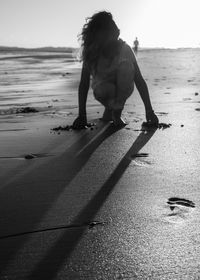 Low section of woman walking on road
