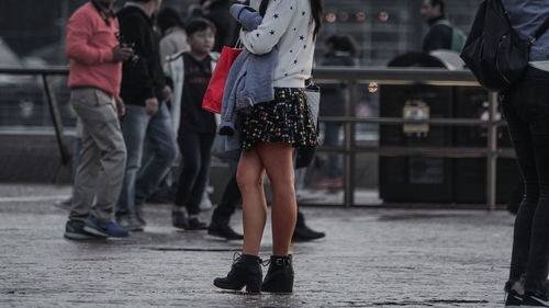 Low section of people walking on street