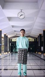 Full length portrait of man standing on tiled floor