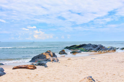 Rocks on beach against sky