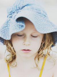 Girl wearing sun hat looking away