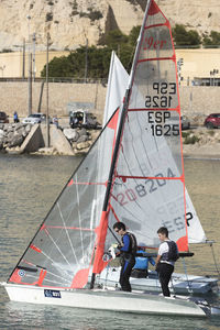People on sailboat against sea