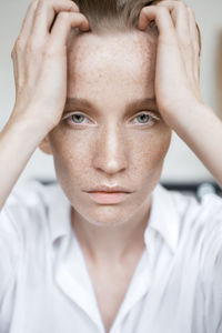 Close-up portrait of woman with head in hands