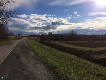 Scenic view of green landscape against sky