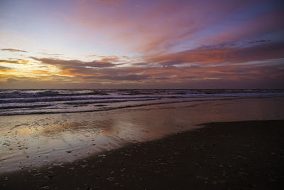 Scenic view of beach against sky during sunset