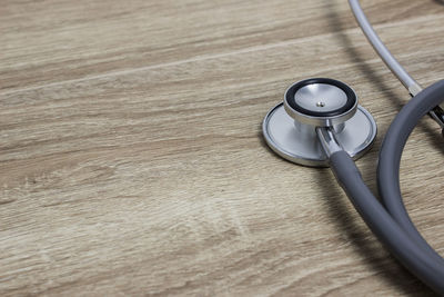 A stethoscope on a wooden table.