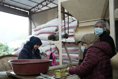 Rear view of woman preparing food at home