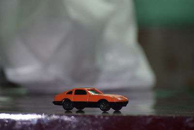 Close-up of toy car on wooden table