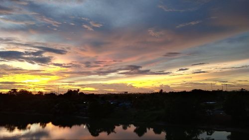 Scenic view of lake against romantic sky at sunset