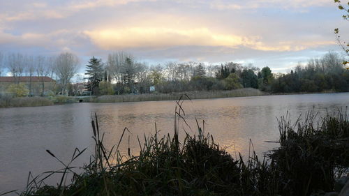 Scenic view of lake against sky during sunset