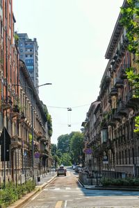 Street amidst buildings against sky in city