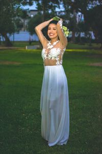 Portrait of smiling young woman standing on field