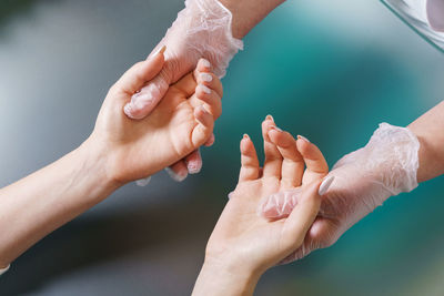 Manicurist does professional light hand massage after manicure procedure.