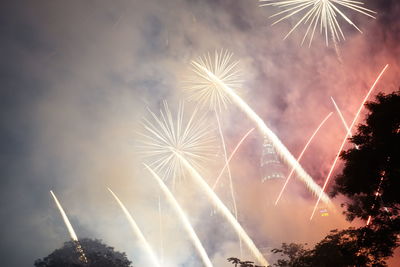 Low angle view of firework display at night