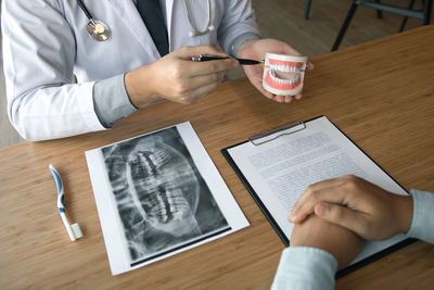 High angle view of man using mobile phone on table