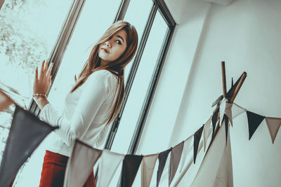 Woman standing by window