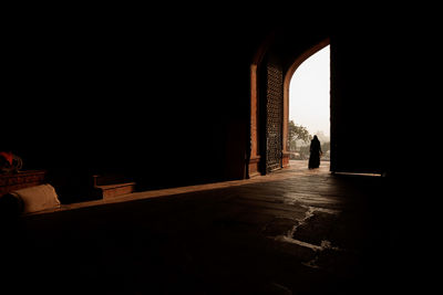 Rear view of woman walking out of mosque