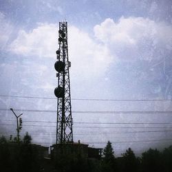 Low angle view of electricity pylon against sky