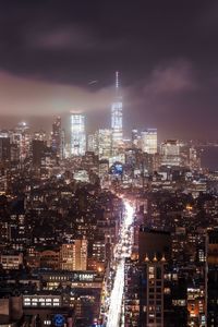 High angle view of illuminated buildings against sky at night