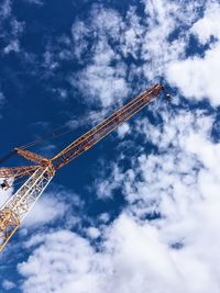 Low angle view of crane against sky