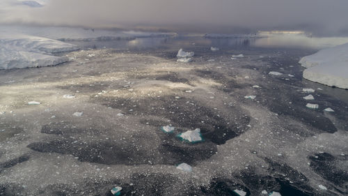 Close-up of frozen lake against sky