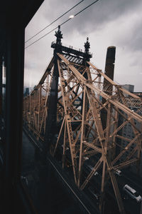 Bridge in city against sky seen through window