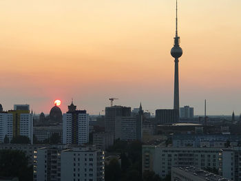 View of buildings in city during sunset